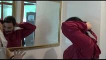 Jill ties, gagges and hoodes herself in front of a mirror and in an strairway wearing a sexy shiny nylon rain pants in black and a red rain jacket (Video)