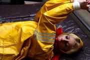 Pia tied and gagged in a shiny nylon rainsuit 