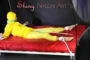 Watching sexy Pia being tied and gagged with ropes on a bed and a clothgag wearing sexy yellow shiny nylon rainwear (Pics)