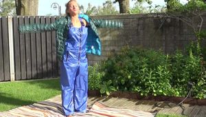 Watching sexy Sandra wearing a sexy blue rainsuit and a green downjacket enjoying the sun and the water in the pool (Video)