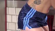Watching sexy COURTNEY wearing a darkblue shiny nylon shorts and a top while preparing coffee and doing her housework (Video)