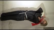 Pia tied, gagged and hooded in a cellar overhead wearing shiny nylon rainwear in black (Video)