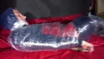 Sexy Sonja wearing an oldschool rainwear suit being tied and gagged with plastic wrap (Video)