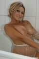 Alexandra takes a hot shower in her transparent body