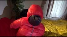 Jill tied, gagged and double-hooded on a bed wearing sexy shiny nylon rain pants and a down jacket (Video)