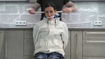 Miss Amira in Farmerrain raingear bound and gagged on a chair