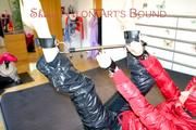 Pia tied and gagged with a bar on bed wearing a supershiny black down pants and a red down jacket (Pics)