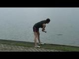 Enni taking a walk on a lake throwing stones into the water and wearing a supersexy shiny nylon shorts and a top (Video)