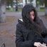 Raven-haired smoker takes a drag on a cork cigarette of her favorite brand