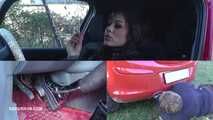 Mistress Cleo steps on the gas pedal and smokes Picture in picture