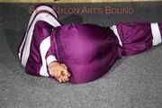Sexy Sandra being tied, gagged and hooded with tape on the floor wearing a supersexy purple rain overall (Pics)