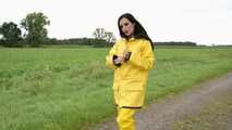 Miss Amira on the road in a Frisian mink, yellow rain dungarees and rubber boots