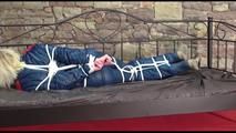 Pia tied and gagged on a princess bed wearing oldschool blue shiny downwear (Video)