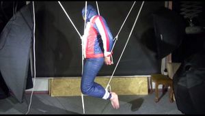 Sonja hanging tied, gagged and hooded with ropes on the ceiling wearing a supersexy oldschool down suit (Video)