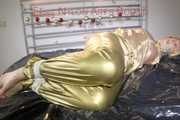 Pia tied, gagged and hooded on bed wearing a sexy golden rain combination and wings (Pics)