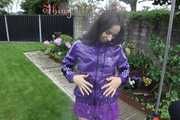 Watching sexy Aiyana wearing a sexy purple shiny nylon shorts and a purple shiny nylon rain jacket enjoying the garden shower (Pics)