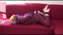 Mara tied and gagged on a red sofa wearing a sexy shiny bordeaux red oldschool skibib (Video)