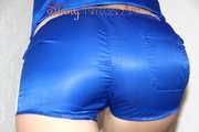 Sonja wearing a sexy blue shiny nylon shorts and a blue rain jacket cleaning up the stairs (Pics)