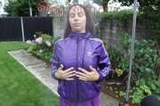 Watching sexy Aiyana wearing a sexy purple shiny nylon shorts and a purple shiny nylon rain jacket enjoying the garden shower (Pics)