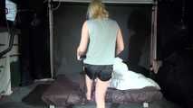 Watching Pia wearing a sexy black/yellow shiny nylon shorts and a grey tshirt while preparing the bed (Video)