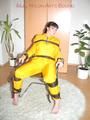 Jill tied, gagged and hooded with a tension belt on a chair wearing a supersexy yellow shiny nylon rainpants and rain jacket (Pics)