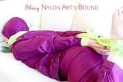 Mara tied and gagged with cloths on a sofa wearing a sexy purple shiny nylon rainwear (Pics)