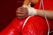 Isabelle tied and gagged in shiny nylon clothes