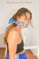 Stella tied and gagged on a chair in spain wearing a blue shiny nylon shorts and a top (Pics)