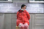 Miss Amira in red nylon rain gear and tranparent rain suit get´s bouind and gagged