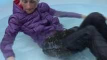 Watching sexy Sonja wearing a sexy shiny nylon rain pant and a purple down jacket enjoying the water in the swimming pool (Video)