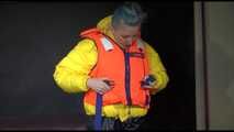 Watching Mara putting on a down jacket, rubber boots and a lifevest (Video)