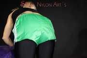 Watching sexy Sandra wearing a sexy black cycling shorts, a top and a sexy green shiny nylon shorts while preparing her bed (Pics)