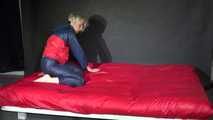 Watching Sonja wearing supersexy red/blue shiny nylon rainwear preparing her bed with shiny nylon cloth (Video)