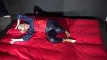 Watching Sonja wearing supersexy red/blue shiny nylon rainwear preparing her bed with shiny nylon cloth (Video)