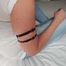 Tight little leather straps around Janes soft upper arms