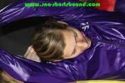 Sandra being tied and gagged overhead with ropes, a bar and a ballgag wearing sexy purple shiny nylon shorts and rain jacket (Pics) 