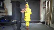 Ms Ungeniert tied, gagged and hooded in shiny nylon yellow Downjacket