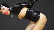 Gagged rubber doll in monogloves