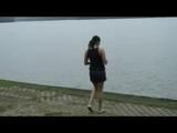 Enni wearing sexy shiny nylon shorts and top while throwing stones in a lake (Video)