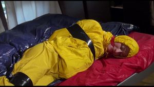Sonja tied, gagged and hooded on bed with tape wearing a supersexy yellow rainwear combination (Video)