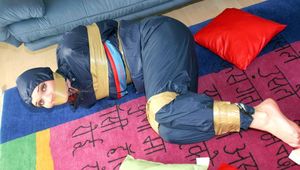 Jill tied, gagged and hooded on the floor with tape wearing an oldschool rain combination (Pics)