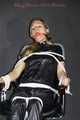 Sexy Sandra being tied and gagged on a haircutter`s chair with ropes and a ball gag wearing a supershiny sexy black rain bib overall (Pics)