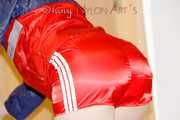 SONJA wearing a sexy red shiny nylon shorts and a red/blue rain jacket cleaning up the flat (Pics)