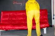 MARA wearing a sexy yellow shiny nylon rain suit lolling and posing on a bed (Pics)