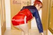 SONJA wearing a sexy red shiny nylon shorts and a red/blue rain jacket cleaning up the flat (Pics)