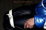 Simone tied and gagged in a shiny nylon down jacket