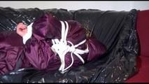 Lucy tied, gagged and hooded on the sofa wearing a sexy purple shiny nylon downwear combination (Video)