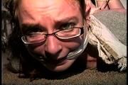 25 Yr OLD NEWS PAPER REPORTER IS MOUTH STUFFED, CLEAVE & HANDGAGGED  WEARING EYE GLASSES, BAREFOOT, TOE-TIED AND HOG-TIED WHILE LAYING ON THE FLOOR (D71-1)