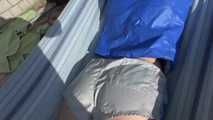 Watching sexy Sonja wearing a grey shiny nylon shorts and a blue rainjacket enjoying the sun (Video)