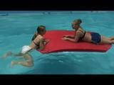 Katharina and Jenny swimming in an indoor pool wearing sexy shiny nylon shorts and bikini-tops (Video)